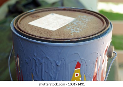 Old Paint Can With Dried Blue Paint Dripping Down Side