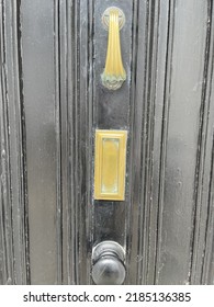 Old Painted Black Front Door With Brass Knocker And Letter Box