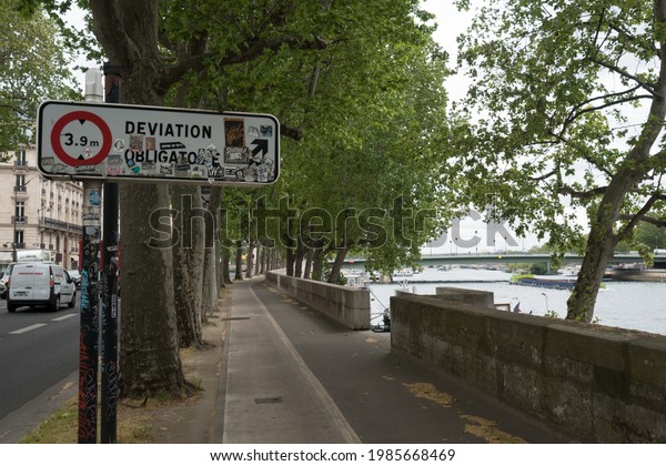 Old\
and painted Deviation Obligatoire (Mandatory deviation) Grunge\
style road direction sign near seine river and alma bridge sign\
Paris France Old and painted Deviation Obligatoire\
