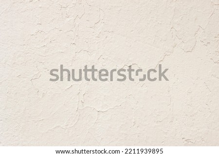 Old painted plaster cream wall, concrete texture. Abstract background