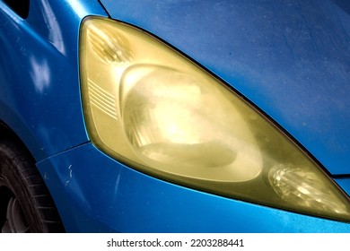 Old Pale Car Headlights, Dull Yellow Car Headlights Caused By Parked Cars In The Sun.