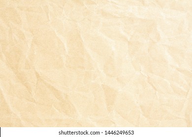 Old pale yellow crumpled paper background texture
