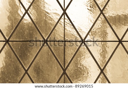 Old paned translucent glass window background (warm tones)