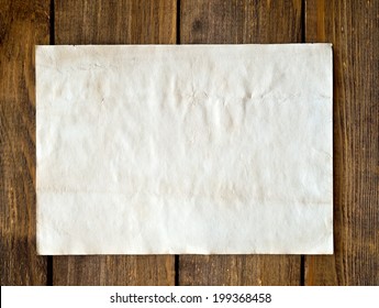 Old Paper On Wood Background