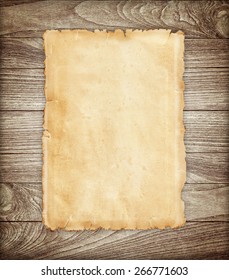 Old paper on wood background. - Shutterstock ID 266771603