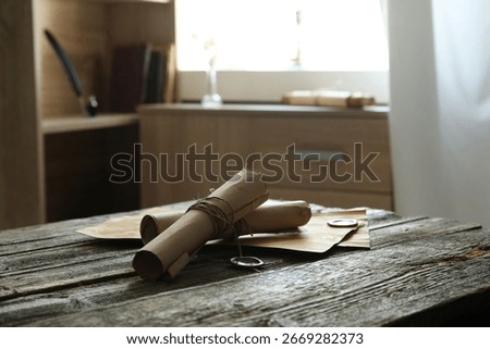 Old paper scrolls and sheets on wooden table