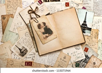 old papers, french post cards and open diary book. romantic vintage background