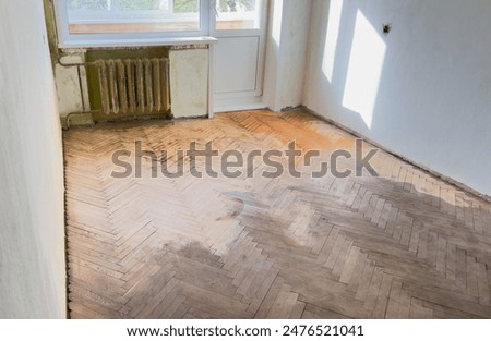 Old parquet background, texture. Old parquet before restoration in an apartment room. Wooden floor background. Old wooden floor in a house.
