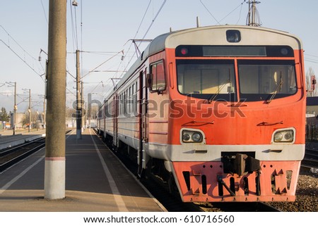 Old passenger train, red. Stands on the platform