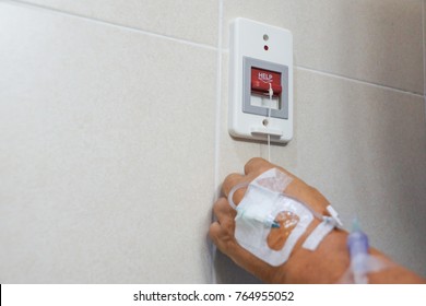 Old patient pulling a red switch calling for emergency help in the toilet