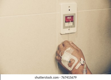 Old patient pulling a red switch calling for emergency help in the toilet