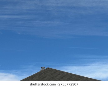Old Patterned roofing shingles forming textured residential roof surface