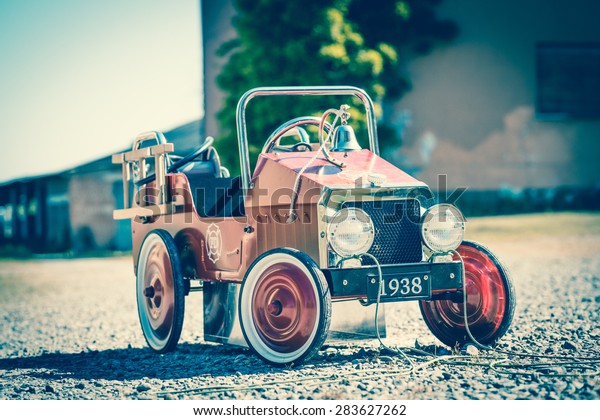 Old pedal firefighter toy\
car