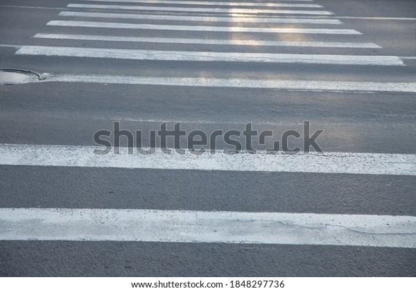 old pedestrian\
crossing over an asphalt\
road