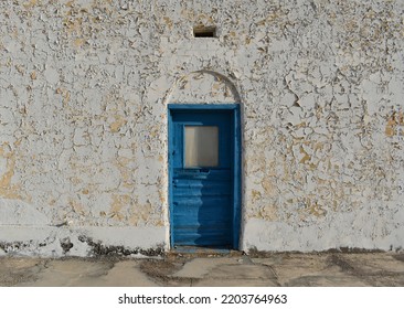 Old Peeling Paint Wall With A Blue Door And A Small Window, Vintage Rustic Background