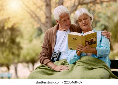 Old, people and book with a mature couple reading in the park for knowledge and education. Bonding, read and love with a husband and wife with a novel or story in a garden relaxing in retirement - Powered by Shutterstock