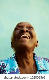Old people and emotions, portrait of bizarre senior african american lady laughing with head tilted up. Copy space