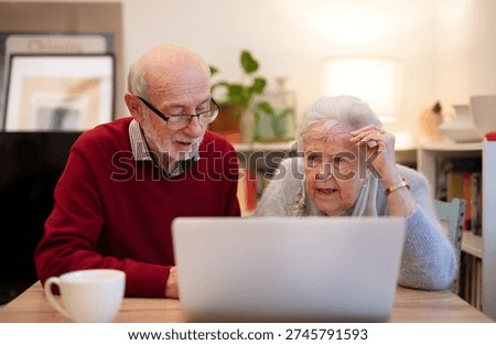 Old people having problem with laptop.