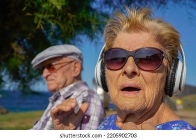 Old People Listen Music In A Park. Music Therapy With Elderly. Active Old Age