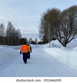 Old People In Sweden Take Walking To Get Some Exercises In The Winter. Often They Wear Reflective Clothing So That Others Can See Them, Because Winter In Sweden Is Not Very Bright.