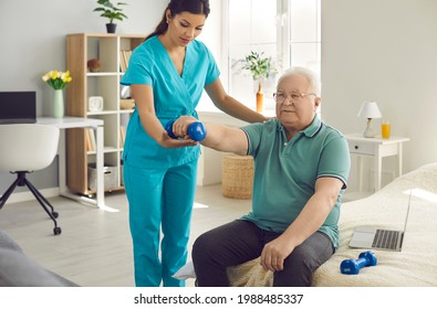 Old people therapy, physical exercise for rehabilitation at home. Senior man physiotherapy training with dumbbells. Female caregiver or nurse physiotherapist in uniform helping aged male patient