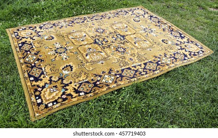 Old Persian Rug On A Green Background