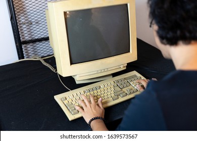 Old Personal Computer With Man Type The Code. Ancient Concept