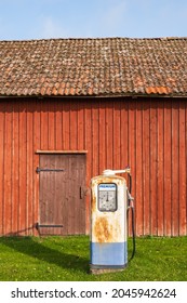 Old Petrol Pump By A Red Barn