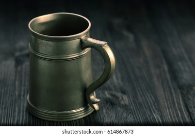 Old Pewter Mug On A Wooden Table