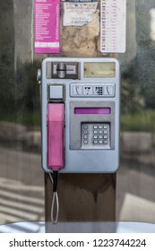 an old phone booth in croatia, with aluminium dial and pink receiver