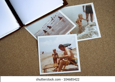 Old photo album and photographs from the early 1970's of family at a beach on a bulletin board. - Powered by Shutterstock