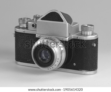 Old photo camera with lens on white background