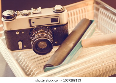 Old photo camera and objects for developing photos. Accessories for developing film and printing photos