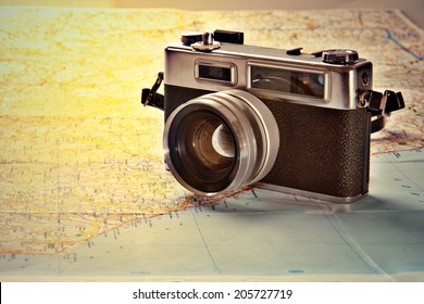 Old photo camera on old map