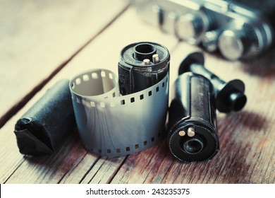 Old Photo Film Rolls, Cassette And Retro Camera On Background. Vintage Stylized.