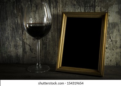 Old Photo Frame On The Wooden Table With Groceries Old Red Wine