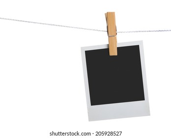 old photo frame palaroid attach to rope clothes peg over white background
