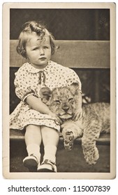 old photo portrait from little girl with tiger baby. vintage picture ca. 1930-40