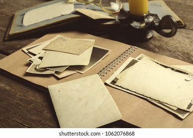old photos on the wooden table - Shutterstock ID 1062076868
