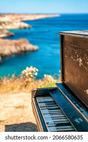 An old piano on Cape Fiolent in the Crimea. A famous place for tourists on the Black Sea coast with azure water