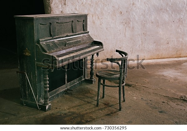 Old piano in a run down\
hall
