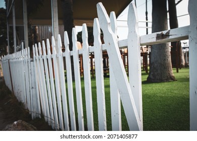 Old picket fence that needs to be repaired - Shutterstock ID 2071405877