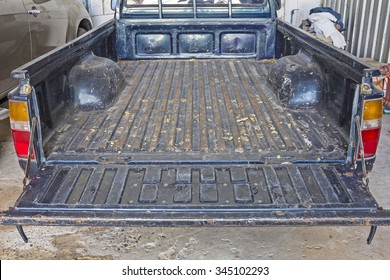 Old Pickup Truck - The Tailgate Of A Blue Battered Eighties Pickup Truck In Rear.