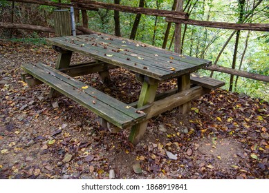 Old Picnic Bench On The Mountain Path. Old And Rotten Wood From The Rain. No Maintenance.