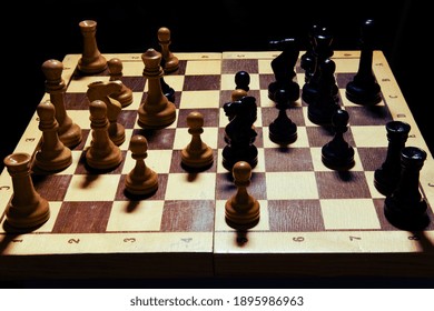 Old Pieces In A Middlegame Position On A Shabby Chessboard