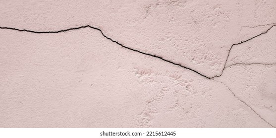 Old Pink Concrete That Cracks Buildings Or Walls Leading To Obvious Crevices.This Can Cause Wear And Tear And Cause Concern Or Trouble For User. Weathered Rough Surface. Texture For Background, Design