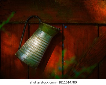 Old Pitcher Hung On Red Barnwood Door.