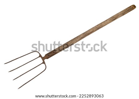 Old pitchfork on a white background. Working farm pitchfork isolated on white background. [[stock_photo]] © 
