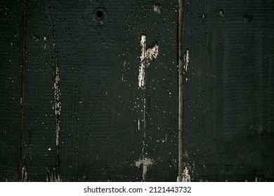 old planks damaged by worms, shown up close, doors painted black, planks joined together
