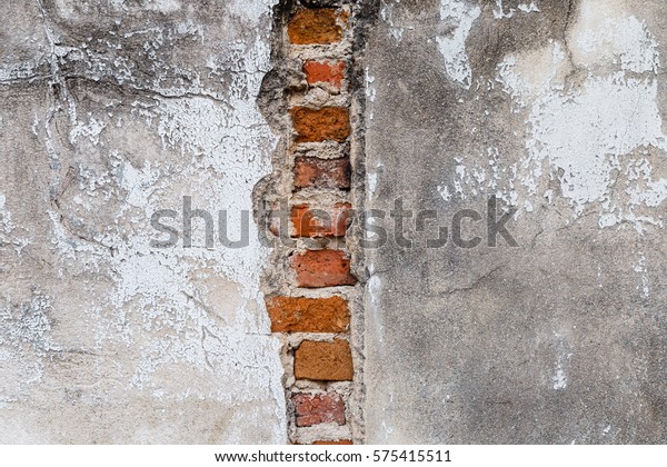Old plaster wall damage for\
background, cement wall with brick cracks in the middle\
row.